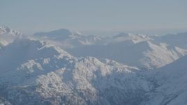 4K aerial stock footage snow covered ranges in Chugach Mountains with low clouds, Alaska Aerial Stock Footage | AK0001_1756
