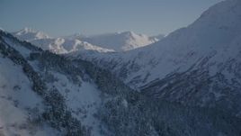 4K aerial stock footage rounding a snowy, forested slope in Chugach Mountains, Alaska Aerial Stock Footage | AK0001_1762