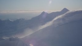 4K aerial stock footage flyby from a windblown snowy peak, Chugach Mountains, Alaska Aerial Stock Footage | AK0001_1779