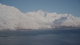 4K aerial stock footage a small, snow covered glacier spilling into the Harriman Fjord, Alaska Aerial Stock Footage | AK0001_1786
