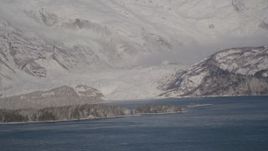4K aerial stock footage a small, snow covered glacier spilling into the Harriman Fjord, Alaska Aerial Stock Footage | AK0001_1788