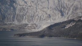4K aerial stock footage flying away from a snow covered glacier spilling into the Harriman Fjord, Alaska Aerial Stock Footage | AK0001_1791