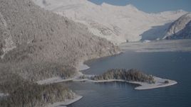4K aerial stock footage descending toward surface of Harriman Fjord, past snowy slopes, Alaska Aerial Stock Footage | AK0001_1792