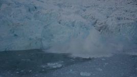 4K aerial stock footage ice breaking off of a snow covered glacier, Harriman Fjord, Alaska Aerial Stock Footage | AK0001_1811