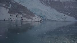 4K aerial stock footage flying low over surface of Harriman Fjord toward snow covered glacier, Alaska Aerial Stock Footage | AK0001_1821
