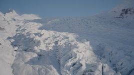 4K aerial stock footage ascend a snowy glacier spilling down mountain slope, Harriman Fjord, Alaska Aerial Stock Footage | AK0001_1824