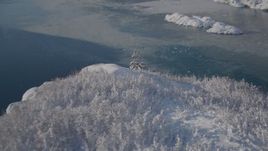 4K aerial stock footage flying down snow covered mountain slope toward water in Harriman Fjord, Alaska Aerial Stock Footage | AK0001_1825