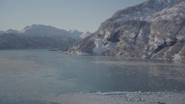 4K aerial stock footage fly over surface of water, Harriman Fjord surrounded by snowy mountains, Alaska Aerial Stock Footage | AK0001_1827