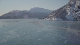 4K aerial stock footage fly low over surface of Harriman Fjord surrounded by snowy mountains, Alaska Aerial Stock Footage | AK0001_1828