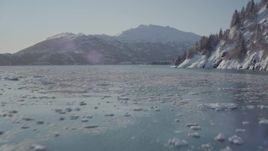 4K aerial stock footage flying low over surface of Harriman Fjord bordered by snowy mountains, Alaska Aerial Stock Footage | AK0001_1829