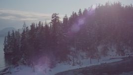 4K aerial stock footage a snow covered, wooded shore at the mouth of a bay, Port Wells, Alaska Aerial Stock Footage | AK0001_1852