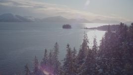 4K aerial stock footage ascend snowy, wooded shore reveal Chugach Mountains, Port Wells, Alaska Aerial Stock Footage | AK0001_1853