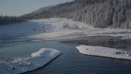 4K aerial stock footage fly over icy shore beside snowy forest in Port Wells, Alaska Aerial Stock Footage | AK0001_1855