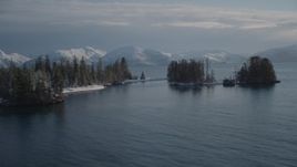 4K aerial stock footage orbiting snow covered wooded islands in Port Wells, Alaska Aerial Stock Footage | AK0001_1859