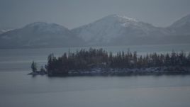 4K aerial stock footage the evergreen trees and snow covered Chugach Mountains across Port Wells, Alaska Aerial Stock Footage | AK0001_1871