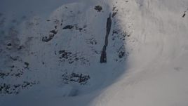 4K aerial stock footage approaching a waterfall on a snowy mountain, Chugach Mountains, Alaska Aerial Stock Footage | AK0001_1892