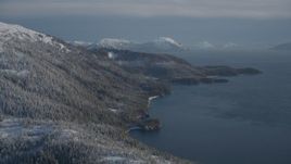 4K aerial stock footage snowy wooded slopes along shore of Pigot Bay, mountains, Port Wells, Alaska Aerial Stock Footage | AK0001_1896