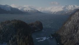 4K aerial stock footage low clouds over snowy Chugach Mountains, Passage Canal, Alaska Aerial Stock Footage | AK0001_1901