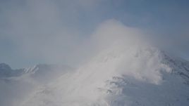 4K aerial stock footage a cloud, snow covered mountain summit, Chugach Mountains, Alaska Aerial Stock Footage | AK0001_1914