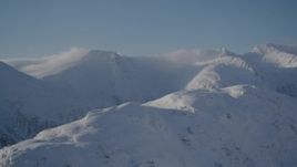 4K aerial stock footage flying past snow covered mountain ranges in Chugach Mountains, Alaska Aerial Stock Footage | AK0001_1919