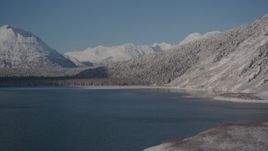 4K aerial stock footage flying over Carmen Lake, snowy Chugach Mountains in the distance, Alaska Aerial Stock Footage | AK0001_1923