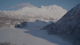 4K aerial stock footage flying over frozen lake at base of snowy Chugach Mountains, Alaska Aerial Stock Footage | AK0001_1925