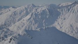 4K aerial stock footage panning across a snowy summit in Chugach Mountains, Alaska Aerial Stock Footage | AK0001_1931