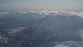 4K aerial stock footage flying by a river valley surrounded by snowy Chugach Mountains, Alaska Aerial Stock Footage | AK0001_1936