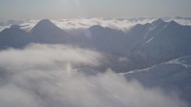 4K aerial stock footage flying by snow covered mountains in Chugach Mountains, Alaska Aerial Stock Footage | AK0001_1938