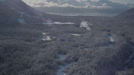 4K aerial stock footage tilt up revealing Girdwood Airport and snow covered Kenai Mountains, Alaska Aerial Stock Footage | AK0001_1958