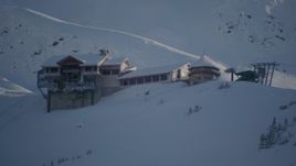 4K aerial stock footage flying away from snow covered ski lodge at summit, Girdwood, Alaska Aerial Stock Footage | AK0001_1963