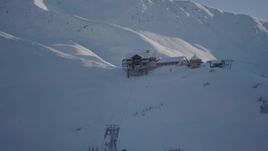 4K aerial stock footage orbiting a snow covered ski lodge at the summit, Girdwood, Alaska Aerial Stock Footage | AK0001_1964