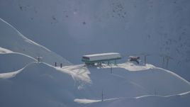4K aerial stock footage orbiting snow covered ski lift, revealing ski lodge, Girdwood, Alaska Aerial Stock Footage | AK0001_1967
