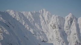 4K aerial stock footage pan across jagged, snowy mountain range in Chugach Mountains, Alaska Aerial Stock Footage | AK0001_1973