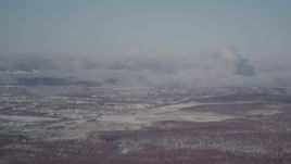 4K aerial stock footage flying over forest near residential neighborhood in Anchorage, Alaska in snow Aerial Stock Footage | AK0001_2007