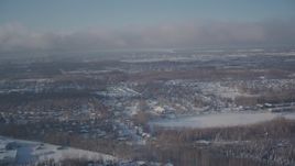 4K aerial stock footage fly over snowy residential neighborhoods toward downtown Anchorage, Alaska Aerial Stock Footage | AK0001_2009