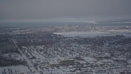 4K aerial stock footage flying over snowy neighborhoods toward Downtown Anchorage, Alaska Aerial Stock Footage | AK0001_2010