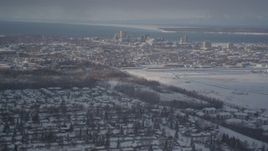4K aerial stock footage flying over snowy neighborhoods toward Downtown Anchorage, Alaska Aerial Stock Footage | AK0001_2011