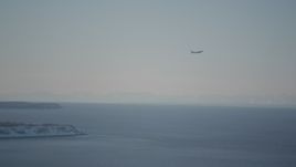 4K aerial stock footage a passenger jet soaring over the Cook Inlet, Anchorage, Alaska in snow Aerial Stock Footage | AK0001_2019