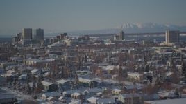 4K aerial stock footage Downtown Anchorage beyond snow covered residential neighborhoods, Alaska Aerial Stock Footage | AK0001_2028