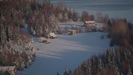4K aerial stock footage cabins in snowy woods in Point MacKenzie, Alaska Aerial Stock Footage | AK0001_2034