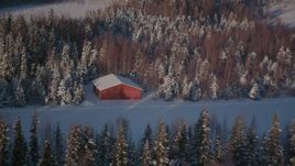 4K aerial stock footage flying away from a small cabin on a snowy road in Point MacKenzie, Alaska Aerial Stock Footage | AK0001_2035