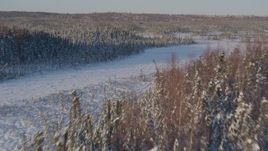 4K aerial stock footage flying over snowy forest and clearings in Point MacKenzie, Alaska Aerial Stock Footage | AK0001_2042
