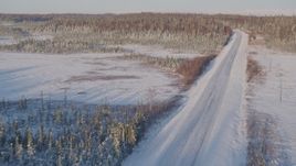 4K aerial stock footage following a deserted snowy rural highway in Point MacKenzie, Alaska Aerial Stock Footage | AK0001_2046