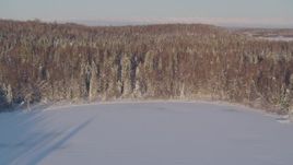 4K aerial stock footage flying over frozen lakes, snowy forest in Big Lake Area, Alaska Aerial Stock Footage | AK0001_2050