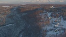 4K aerial stock footage approach Shawn Field, reveal snowy neighborhood in Wasilla, Alaska, sunset Aerial Stock Footage | AK0001_2071