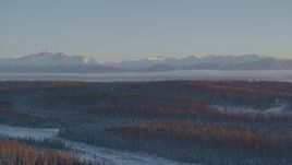 4K aerial stock footage snow covered Chugach Mountains seen from Wasilla at sunset, Alaska Aerial Stock Footage | AK0001_2075