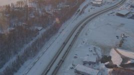 4K aerial stock footage train by snowy neighborhoods, George Parks Highway, Wasilla, Alaska, sunset  Aerial Stock Footage | AK0001_2077