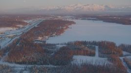 4K aerial stock footage Lucile Lake, moon over snowy Chugach Mountains, Wasilla, Alaska, sunset Aerial Stock Footage | AK0001_2082