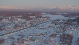 4K aerial stock footage Lucile Lake toward Wasilla Lake with snow on the ground at twilight, Alaska Aerial Stock Footage | AK0001_2087